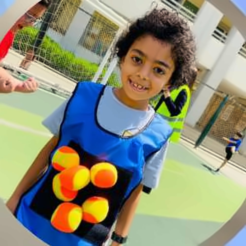 A boy in a target vest covered in sticky balls