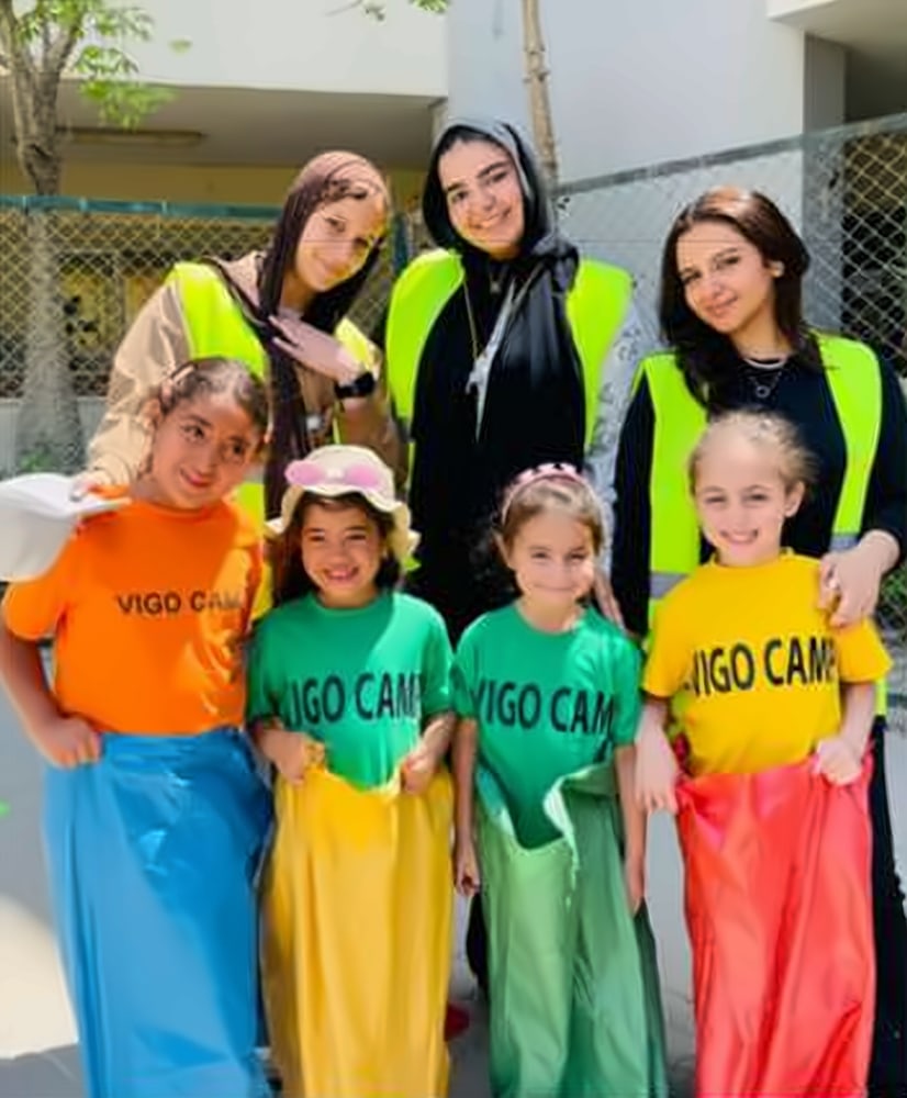 Girls ready for the sack race with their coaches