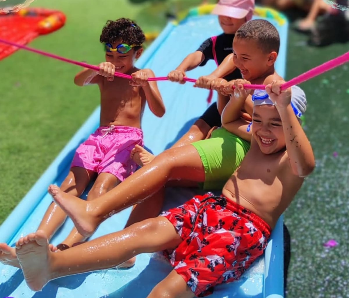Kids laughing on a water slide at Vigo Camp